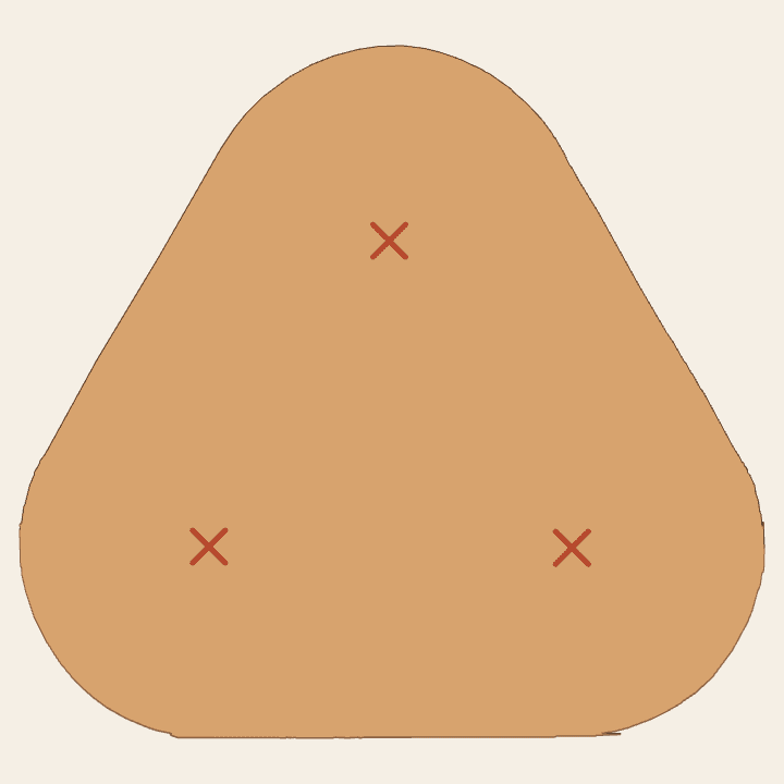 Pattern-cut rounded triangular base with three X marks before the holes are bored.